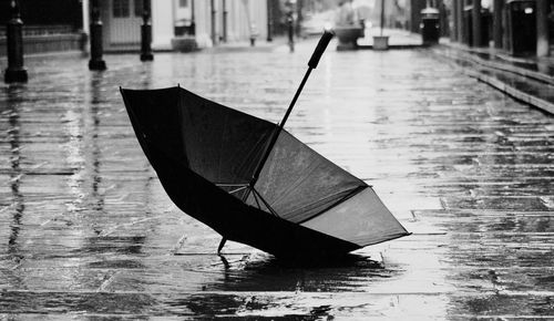 Close-up of wet umbrella in city during rainy season