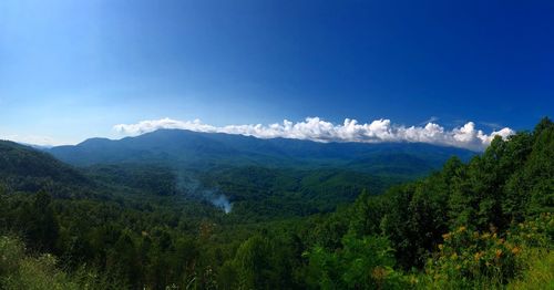 Scenic view of mountains against blue sky