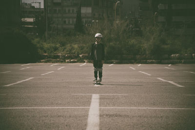 Full length of boy walking on road