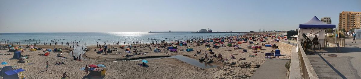 People at beach against sky