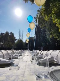 Empty chairs and table against trees