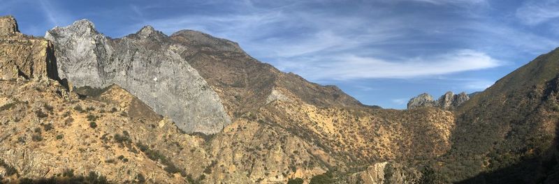 Low angle view of rocky mountains against sky