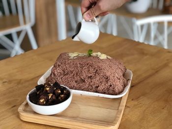 Midsection of person preparing food on table