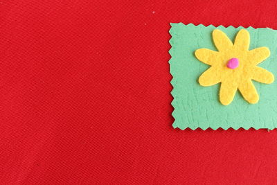 Directly above shot of christmas decorations on red textile