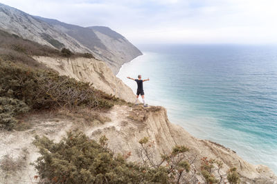 Man looking at sea against sky