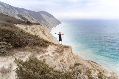 Man looking at sea against sky