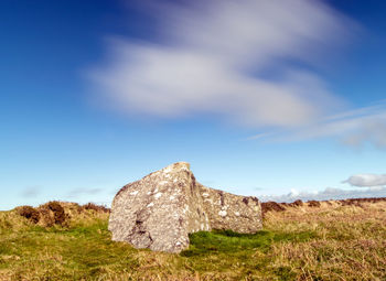 Rocks on field against sky