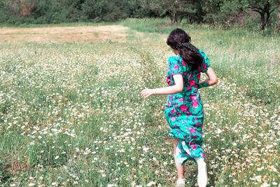 Rear view of woman on field