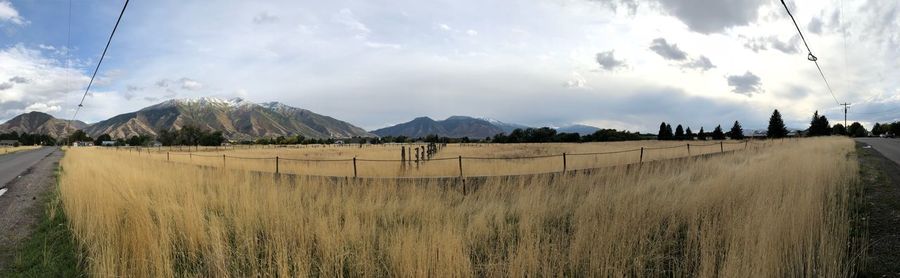 Panoramic view of field against sky