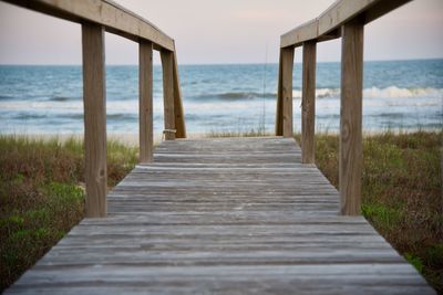 Pier over sea against sky