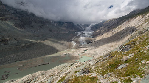 Scenic view of river and mountains at waidring