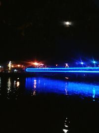 View of illuminated street lights at night