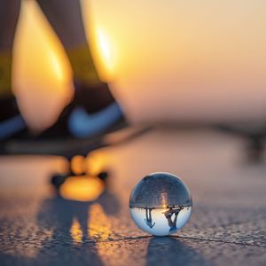 Close-up of illuminated ball on table against sky during sunset