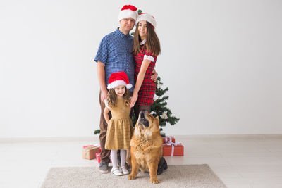 Woman with dog with arms outstretched against white background