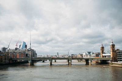 View of bridge over river against cloudy sky