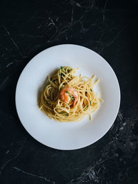 High angle view of spaghetti with shrimps in plate on table