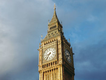 Low angle view of clock tower against sky