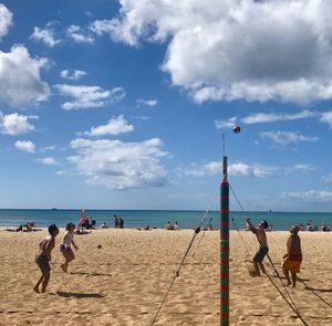People on beach against sky