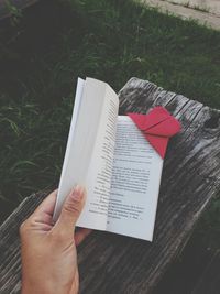 Midsection of person holding book