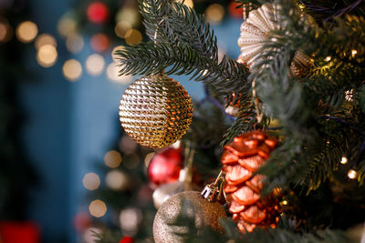 Close-up of christmas decorations hanging on tree