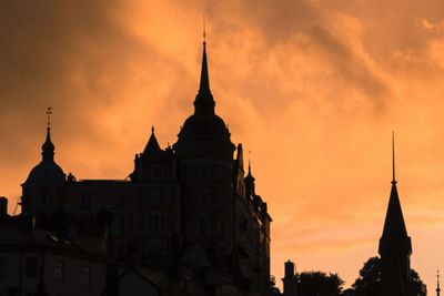 Silhouette of buildings against sky during sunset