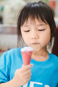 Portrait of cute girl holding ice cream