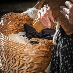 Midsection of woman holding wicker basket