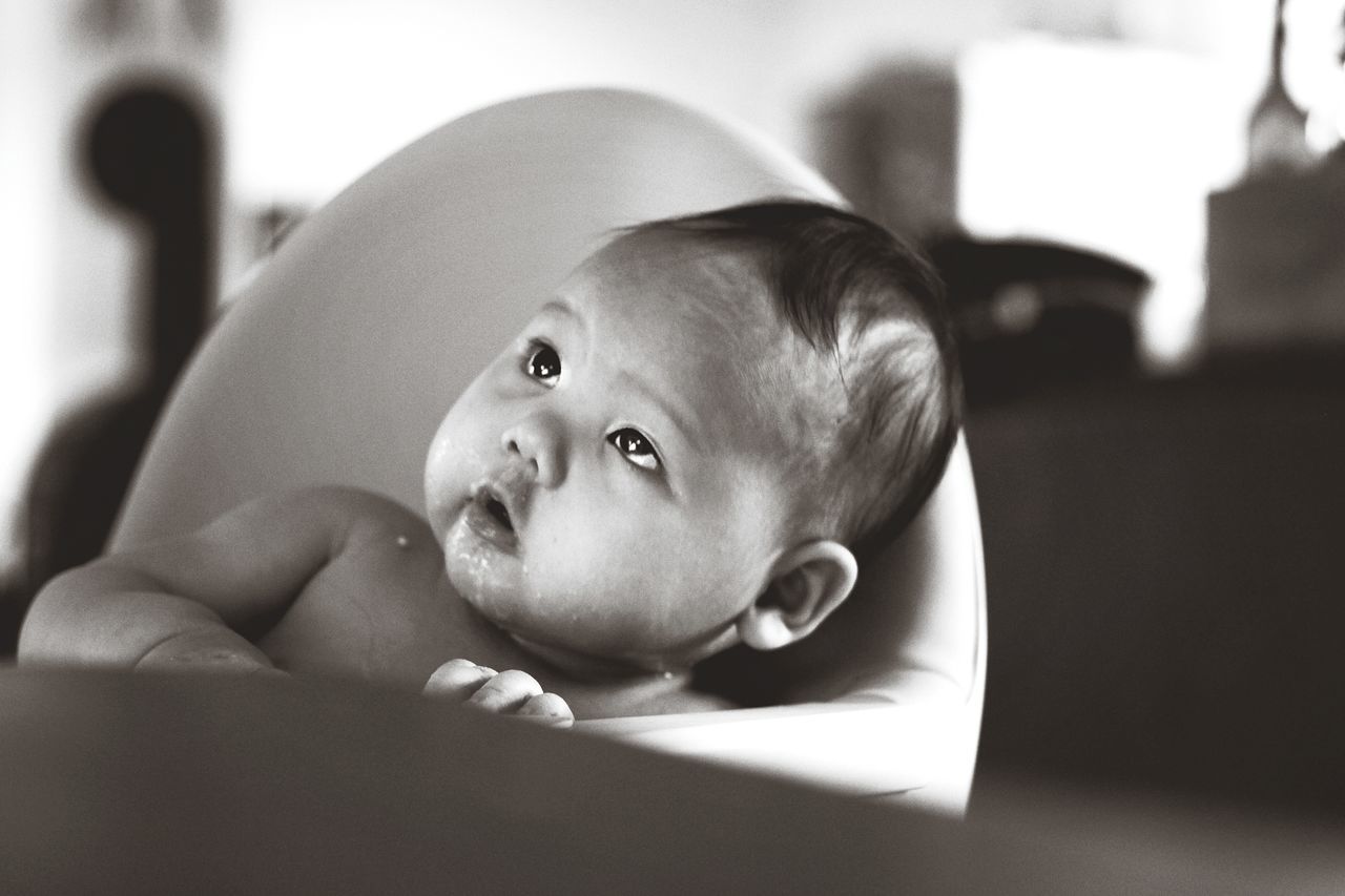 young, baby, child, childhood, real people, babyhood, portrait, innocence, one person, indoors, headshot, cute, looking away, looking, toddler, beginnings, lying down, lifestyles