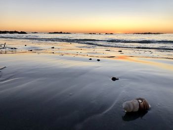 Scenic view of beach against sky during sunset