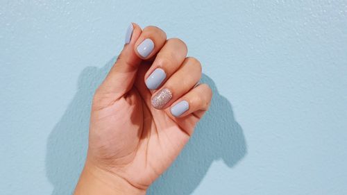 Close-up of woman hand on wall