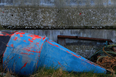 Abandoned boat against wall
