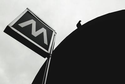 Low angle view of road sign against sky