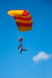 Low angle view of kite flying against blue sky