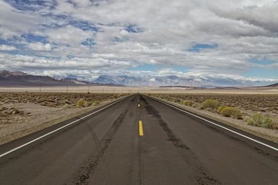 Empty road along countryside landscape