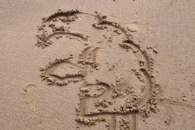 High angle view of footprints on sand