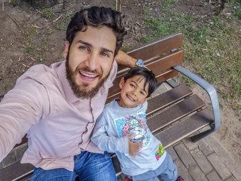 Portrait of happy family sitting outdoors