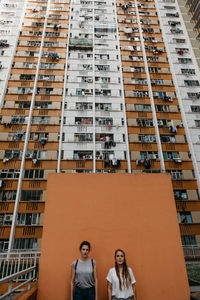 Female friends against building in city