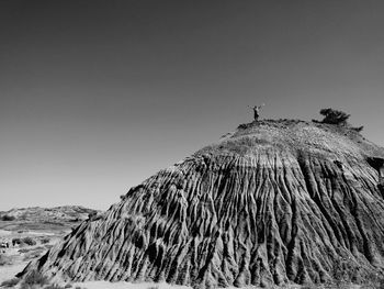 Low angle view of horse on mountain against sky