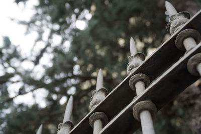 Low angle view of sculpture against trees