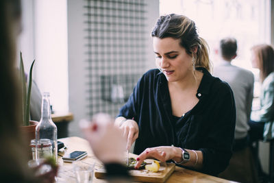 Young woman sitting at restaurant table