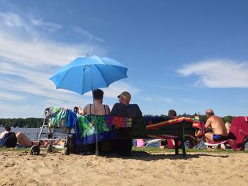 Tourists sitting on beach