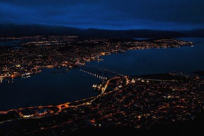 Aerial view of tromso bridge and illuminated cityscape at night