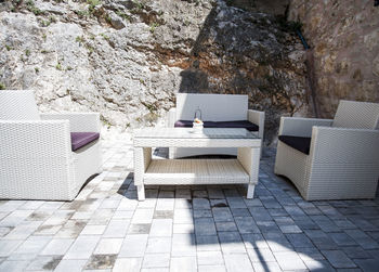 Chairs on sofa against building