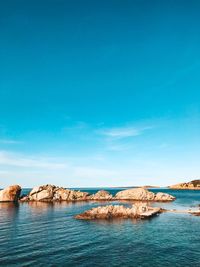 Scenic view of sea against blue sky