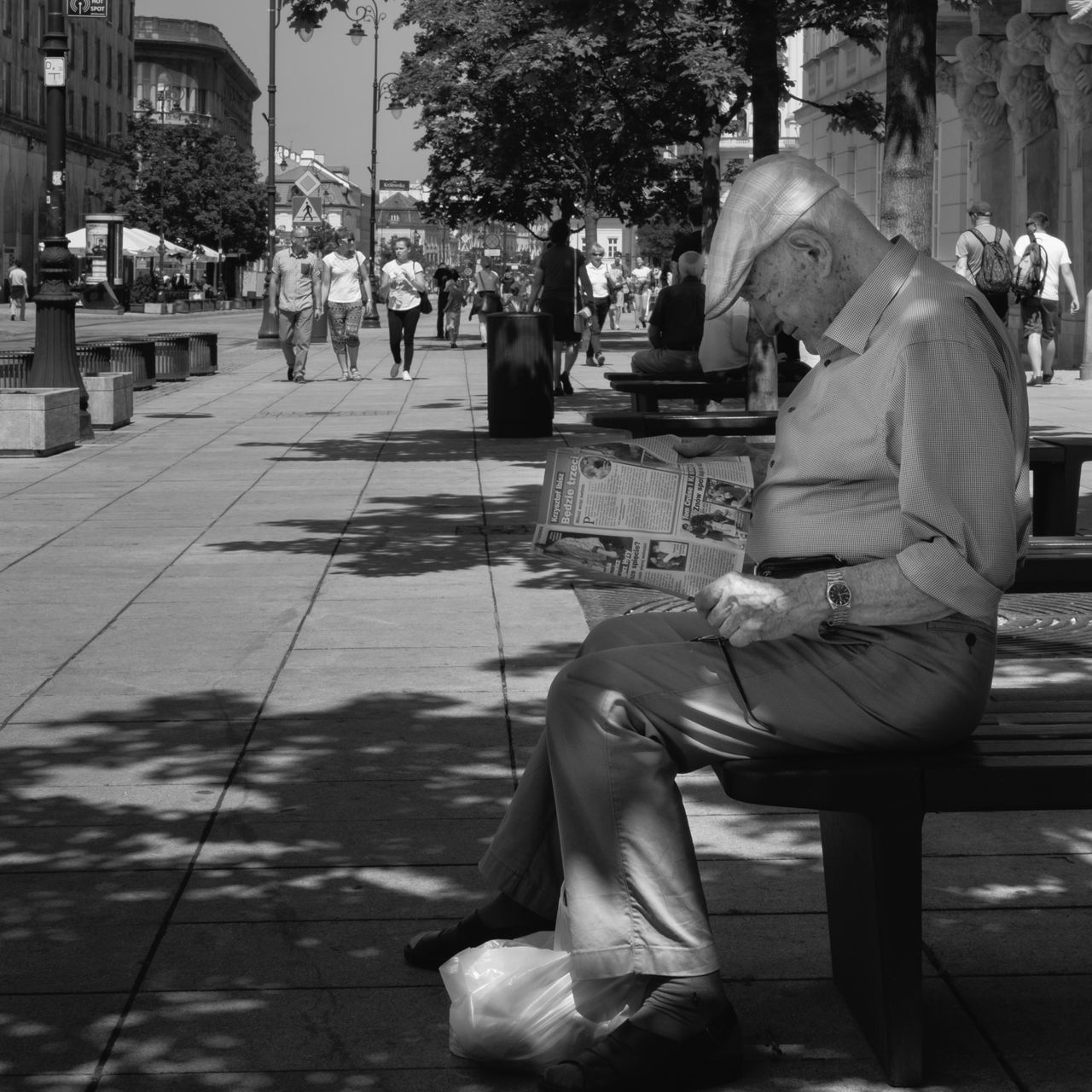 building exterior, statue, built structure, sculpture, architecture, city, human representation, street, sitting, incidental people, art and craft, full length, art, lifestyles, tree, person, sunlight