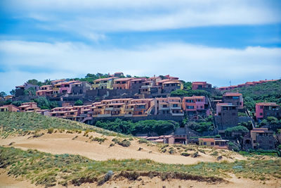 Buildings in town against sky