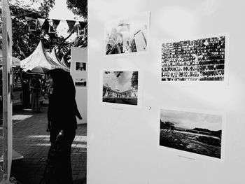 Rear view of man standing against wall in city