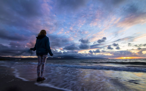 Rear view of man standing on beach