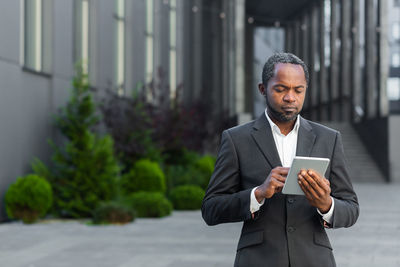 Portrait of businessman using mobile phone