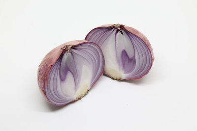 Close-up of purple candies against white background